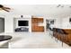 Stylish living space with dark-wood cabinets, a large screen television, and tile flooring at 2710 E Cinnabar Ave, Phoenix, AZ 85028