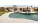 Backyard pool with lounge chairs, covered patio, outdoor grill, and well-manicured green lawn at 2710 E Cinnabar Ave, Phoenix, AZ 85028