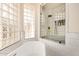 Bright bathroom boasts a modern shower, glass block window, and freestanding tub, creating a spa-like retreat at 2732 E Hillery Dr, Phoenix, AZ 85032