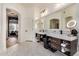 Bright bathroom features double sinks, white marble floors, and modern lighting for a luxurious experience at 2732 E Hillery Dr, Phoenix, AZ 85032