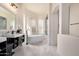 Elegant bathroom boasts a freestanding tub, glass block window, walk-in shower, and modern fixtures at 2732 E Hillery Dr, Phoenix, AZ 85032