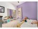 Charming room with purple walls, sliding door closet, and a cozy toddler bed with toys at 2732 E Hillery Dr, Phoenix, AZ 85032