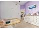 Cozy toddler bedroom with charming purple walls, a dresser, and a comfortable toddler bed at 2732 E Hillery Dr, Phoenix, AZ 85032