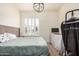 Bright bedroom features a shuttered window and contemporary light fixture at 2732 E Hillery Dr, Phoenix, AZ 85032