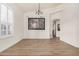 Bright dining room with wood floors, shutters, chandelier and modern art at 2732 E Hillery Dr, Phoenix, AZ 85032