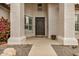 Inviting front porch with decorative columns, large entryway door, and charming landscaping at 2732 E Hillery Dr, Phoenix, AZ 85032