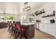 Bright kitchen with island seating, white cabinets, and stainless appliances at 2732 E Hillery Dr, Phoenix, AZ 85032