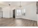 Bright open living space featuring light wood floors, modern lighting, and large windows at 2732 E Hillery Dr, Phoenix, AZ 85032
