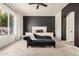 Spacious main bedroom with accent wall, lounge chair, and natural light at 2732 E Hillery Dr, Phoenix, AZ 85032
