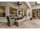 Covered patio with stone tile, ceiling fan, and outdoor dining set at 2732 E Hillery Dr, Phoenix, AZ 85032