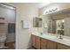 Well-lit bathroom featuring a dual sink vanity, large mirror and neutral color scheme at 2875 W Highland St # 1152, Chandler, AZ 85224