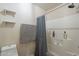 Bright bathroom with tiled shower, white shelves and neutral paint at 2875 W Highland St # 1152, Chandler, AZ 85224