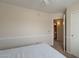 Neutral bedroom featuring a doorway to a bathroom and neutral carpeting at 2875 W Highland St # 1152, Chandler, AZ 85224