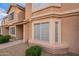 Charming townhome showcasing a stucco exterior, well-manicured landscaping, and decorative window accents at 2875 W Highland St # 1152, Chandler, AZ 85224