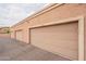 Exterior shot of multiple garages showing paneled doors matching the tan stucco of the building's exterior at 2875 W Highland St # 1152, Chandler, AZ 85224