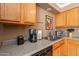 The kitchen features wood cabinets, granite countertops, and stainless steel appliances at 2875 W Highland St # 1152, Chandler, AZ 85224