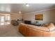 Inviting living room featuring neutral paint, plush carpeting, and a comfortable leather sofa at 2875 W Highland St # 1152, Chandler, AZ 85224