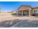 The backyard features a covered patio, gravel landscaping, and a built-in BBQ at 3028 W T Ryan Ln, Phoenix, AZ 85041