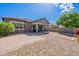 Spacious backyard with gravel landscaping, a covered patio, and a block wall fence for privacy at 3028 W T Ryan Ln, Phoenix, AZ 85041