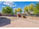 Landscaped backyard featuring gravel and a paved patio area at 3028 W T Ryan Ln, Phoenix, AZ 85041