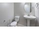 This powder room has a toilet, pedestal sink and round mirror at 3028 W T Ryan Ln, Phoenix, AZ 85041