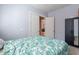 This bedroom has a queen bed and an open door to an adjoining room at 3028 W T Ryan Ln, Phoenix, AZ 85041