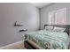 A simply decorated bedroom with a queen bed, tile floors, and natural lighting at 3028 W T Ryan Ln, Phoenix, AZ 85041