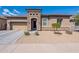 Inviting single-story home with a stone-accented entrance, desert landscaping, and a two-car garage at 3028 W T Ryan Ln, Phoenix, AZ 85041