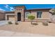 Attractive single-story house showcasing a stone entryway, easy-care desert landscape, and a two-car garage at 3028 W T Ryan Ln, Phoenix, AZ 85041