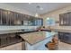 Stylish kitchen featuring dark wood cabinets, granite countertops, and stainless steel appliances at 3028 W T Ryan Ln, Phoenix, AZ 85041