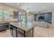 Granite island complements this kitchen with stainless appliances, dark cabinets, and backyard access at 3028 W T Ryan Ln, Phoenix, AZ 85041