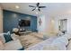 Cozy living room features a comfortable sofa, a large television, and a ceiling fan at 3028 W T Ryan Ln, Phoenix, AZ 85041