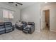 This living room includes a dark leather sofa and tile floors at 3028 W T Ryan Ln, Phoenix, AZ 85041