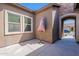 Covered side patio area with sun umbrella and neutral wall tone at 3028 W T Ryan Ln, Phoenix, AZ 85041