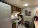 Traditional kitchen with wooden cabinets, white appliances, and bright lighting at 3033 E Devonshire Ave # 3003, Phoenix, AZ 85016