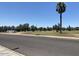 Street view of property featuring a well-maintained green space with mature olive trees at 3033 E Devonshire Ave # 3003, Phoenix, AZ 85016
