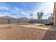 Spacious backyard features gravel ground cover, brick patio, basketball court, and block wall at 30993 W Indianola Ave, Buckeye, AZ 85396