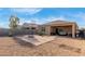 Inviting backyard features brick patio, gravel ground cover, basketball court, covered patio with seating and grill at 30993 W Indianola Ave, Buckeye, AZ 85396