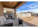 Outdoor patio features comfortable lounge furniture and a built in grill for easy outdoor entertaining at 30993 W Indianola Ave, Buckeye, AZ 85396