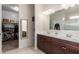 Bathroom features a double sink vanity, walk in shower and walk in closet at 30993 W Indianola Ave, Buckeye, AZ 85396