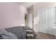 Bedroom features a double closet with sliding doors and views of ensuite bathroom at 30993 W Indianola Ave, Buckeye, AZ 85396