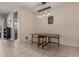 Well-lit dining room features neutral walls, drop-leaf dining table, and a stylish decorative light fixture at 30993 W Indianola Ave, Buckeye, AZ 85396