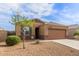 Single-story home with desert landscaping, neutral colors, and a two-car garage at 30993 W Indianola Ave, Buckeye, AZ 85396