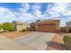 Single-story home featuring desert landscaping, neutral color palette, and a two-car garage at 30993 W Indianola Ave, Buckeye, AZ 85396