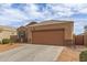 Single-story home with desert landscaping, neutral colors, and a two-car garage at 30993 W Indianola Ave, Buckeye, AZ 85396