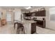 Spacious kitchen with stainless steel appliances, granite countertops, and a large island with breakfast bar seating at 30993 W Indianola Ave, Buckeye, AZ 85396
