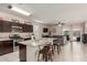 Open kitchen view featuring stainless steel appliances, granite countertops, breakfast bar, and open to the living room at 30993 W Indianola Ave, Buckeye, AZ 85396