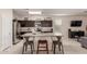 A kitchen featuring stainless steel appliances, granite countertops, and a center island with bar seating at 30993 W Indianola Ave, Buckeye, AZ 85396