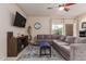 Cozy living room featuring modern furniture, neutral tones, and a ceiling fan at 30993 W Indianola Ave, Buckeye, AZ 85396