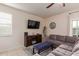 Cozy living room featuring modern furniture, neutral tones, and a ceiling fan at 30993 W Indianola Ave, Buckeye, AZ 85396